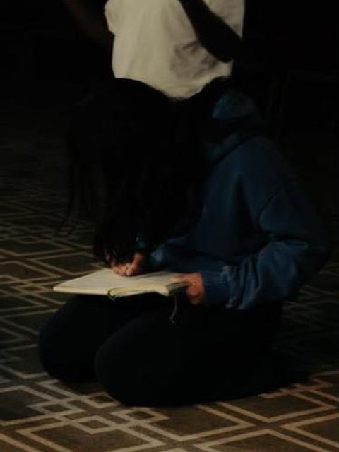 Kneeling in prayer with a journal