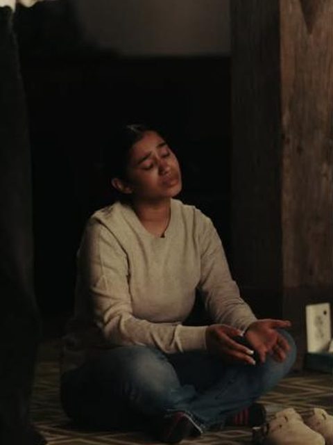 A young woman praying on the floor