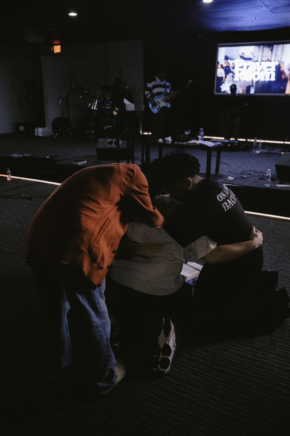 Young adults praying together at a prayer room